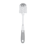 Cepillo limpia biberones OXO Tot con limpiador de tetinas y soporte gris